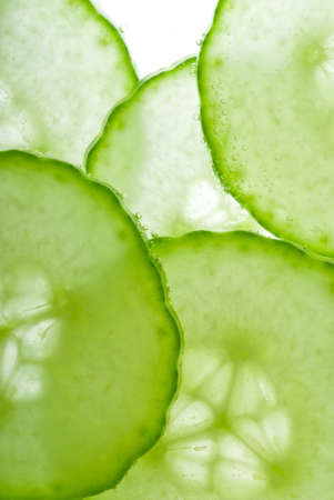 Green cucumber slices backlit in studio macroの写真素材