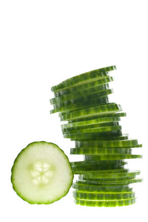 A tower of green vegetable slices on whiteの写真素材