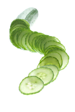 Focus play with a cucumber slices on whiteの写真素材