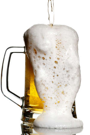 Overflowing beer from a heavy keg isolated on whiteの写真素材