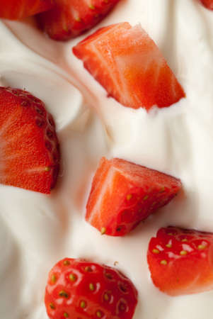 Sliced red strawberry in white creamの写真素材