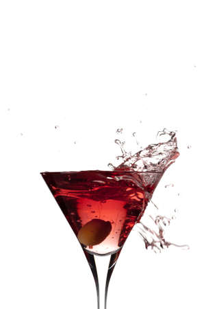 Overflowing glass of martini wth an oliveの写真素材