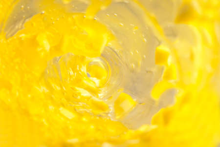 Citrus juice swirling in a glass bottleの写真素材