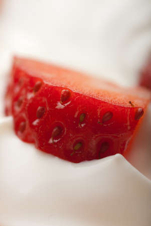 Closeup of a strawberry slice in defocus blurの写真素材