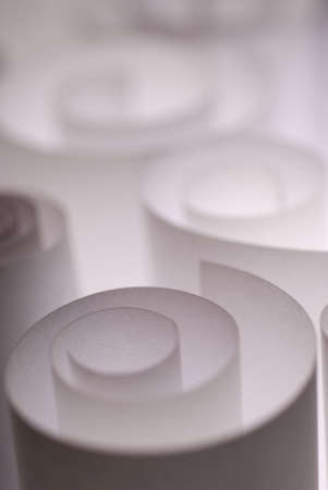 Selective focus on white curled paper pieces