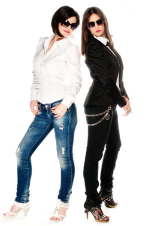 Two brunette girls in studio isolated on whiteの写真素材