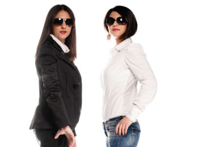 Black vs White clothes on two girls isolated on whiteの写真素材