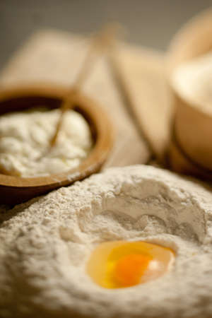 Defocused table with a heap of powder and a yolkの写真素材
