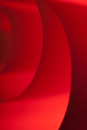 Spiraled red paper with a texture under soft lightの写真素材