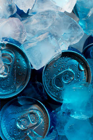 Soda tin cans with condensation and under iceの写真素材