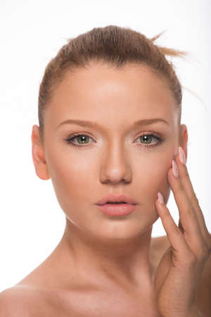 Portrait of a beautiful Caucasian woman with perfect face on white backgroundの写真素材