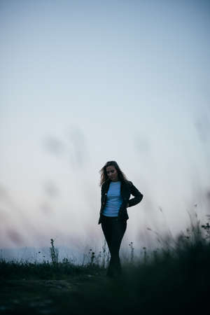 Brunette girl in late autumn walking outdoorsの写真素材