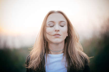 Brunette girl carried-away while daydreamingの写真素材