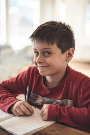 Boy doing homework at homeの写真素材