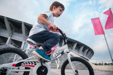 Kid riding a bicycle with low angle photoの写真素材