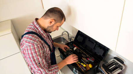 Repairman searching his toolの写真素材