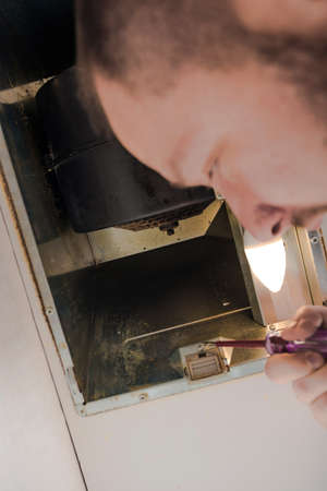 Electrician getting ready to fix the ventilation