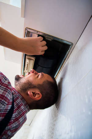 Electrician getting ready to fix the ventilation