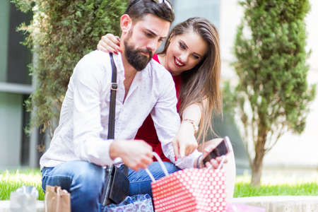 Shopping in the down town.Lovely couple having fun on the Macedonian streets,on a sunshine day.の写真素材