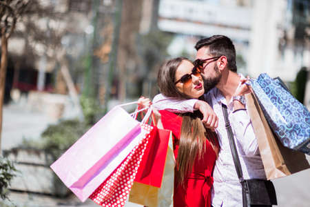 Shopping in the city.Lovely couple having fun on the Macedonian streets,on a sunshine day.の写真素材
