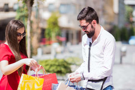 Shopping in the down town.Lovely couple having fun on the Macedonian streets,on a sunshine day.の写真素材