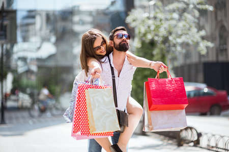 Shopping in the city.Lovely couple having fun on the Macedonian streets,on a sunshine day.の写真素材