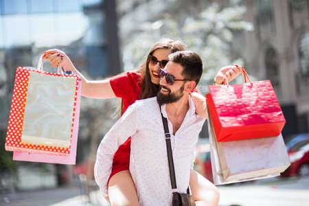 Shopping in the city.Lovely couple having fun on the Macedonian streets,on a sunshine day.の写真素材