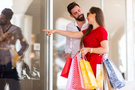 Shopping in the down town.Lovely couple having fun on the Macedonian streets,on a sunshine day.の写真素材