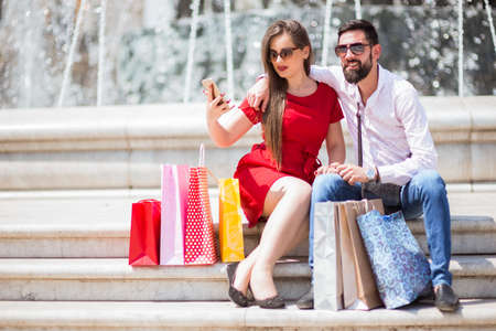 Shopping in the down town.Lovely couple having fun on the Macedonian streets,on a sunshine day.の写真素材