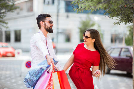 Shopping in the city.Lovely couple having fun on the Macedonian streets,on a sunshine day.の写真素材