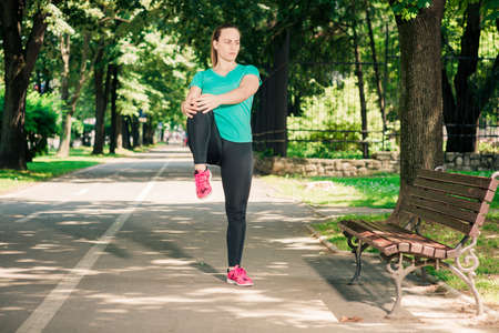 Girl working stretching leg muscles warm upの写真素材