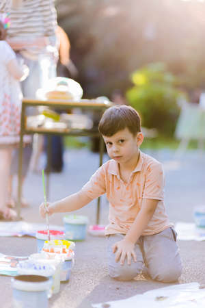 Toddler prepare to painting with watercolors into the parkの写真素材