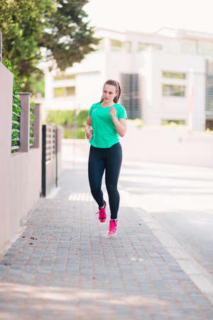Positive active young fitness woman warming up and stretchingの写真素材