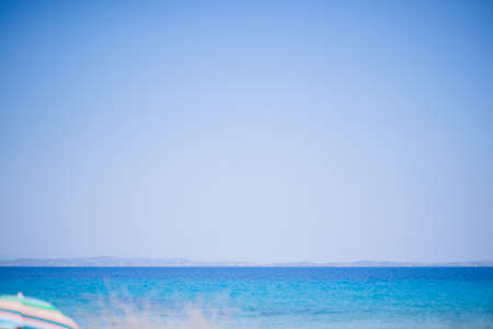 Beach and Sea on a beautiful summer day with clear sky and people swimmingの写真素材