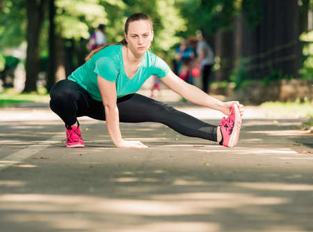 Young girl doing stretching exerciseの写真素材