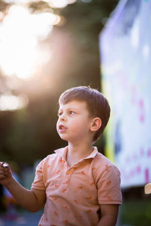Portrait of young boy enjoying in the city park and having funの写真素材