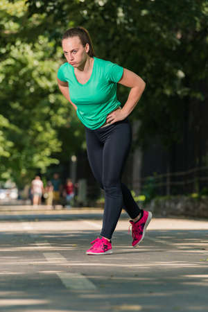 Picture of sporty young woman stretching on the running trackの写真素材
