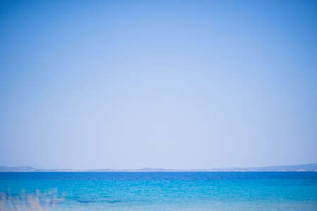 Beach and Sea on a beautiful summer day with clear sky and people swimmingの写真素材