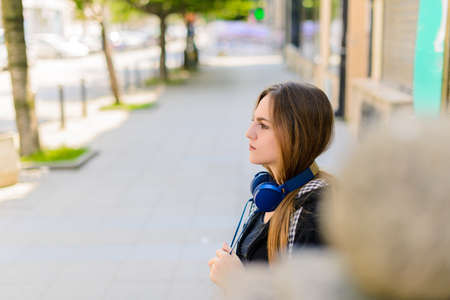 Attractive girl with headphones enjoying in the city centerの写真素材