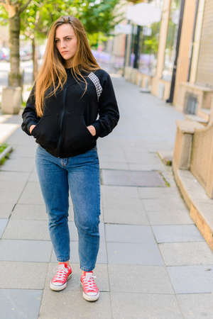 Full length portrait of a young lady walking outdoorの写真素材