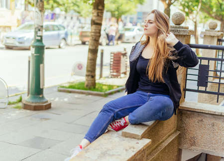 Portrait of young beautiful haired woman, on summer sceneの写真素材