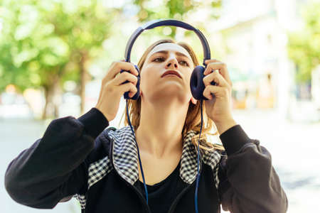 Close up face of beautiful  girl listening to music with professional headphonesの写真素材
