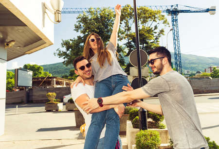 A group of friends walking on the sidewalk in an urban place