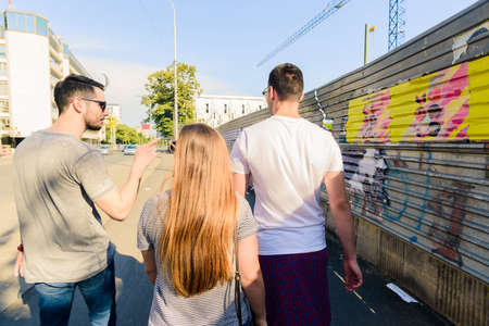Group of friends having fun outdoors in sunny day in downtownの写真素材