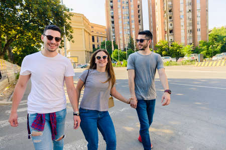 Group of young best friends having fun together walking on town streetの写真素材