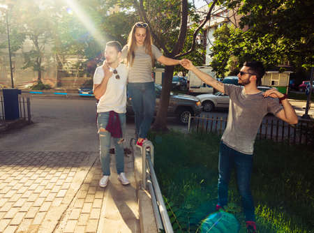 Group of young best friends having fun together walking on town streetの写真素材