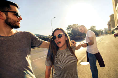 A group of young people walking through the street in a city