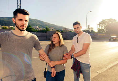 Group of friends enjoying in summer time while walking on sunsetの写真素材