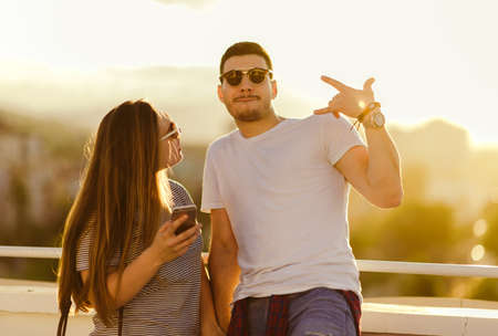 Sensual couple enjoying on sunset and having fun on the balcony