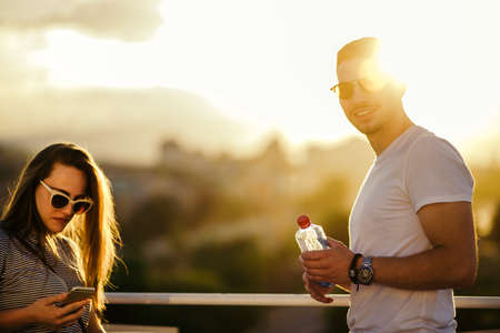 Beautiful young couple amuse on the balcony in summer timeの写真素材